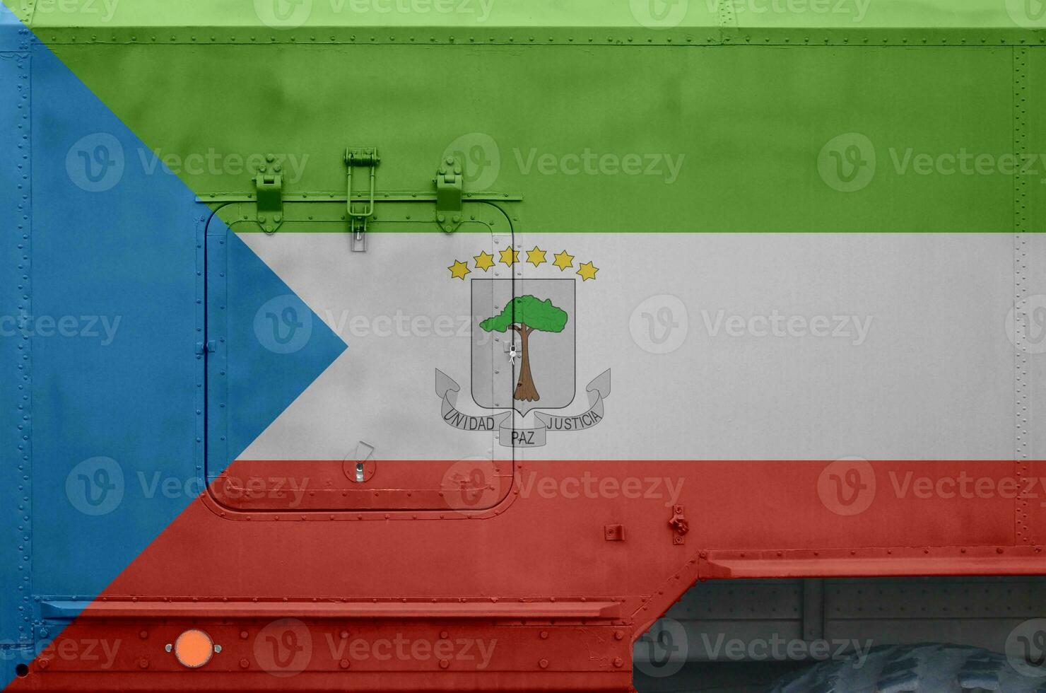 Equatorial Guinea flag depicted on side part of military armored truck closeup. Army forces conceptual background photo