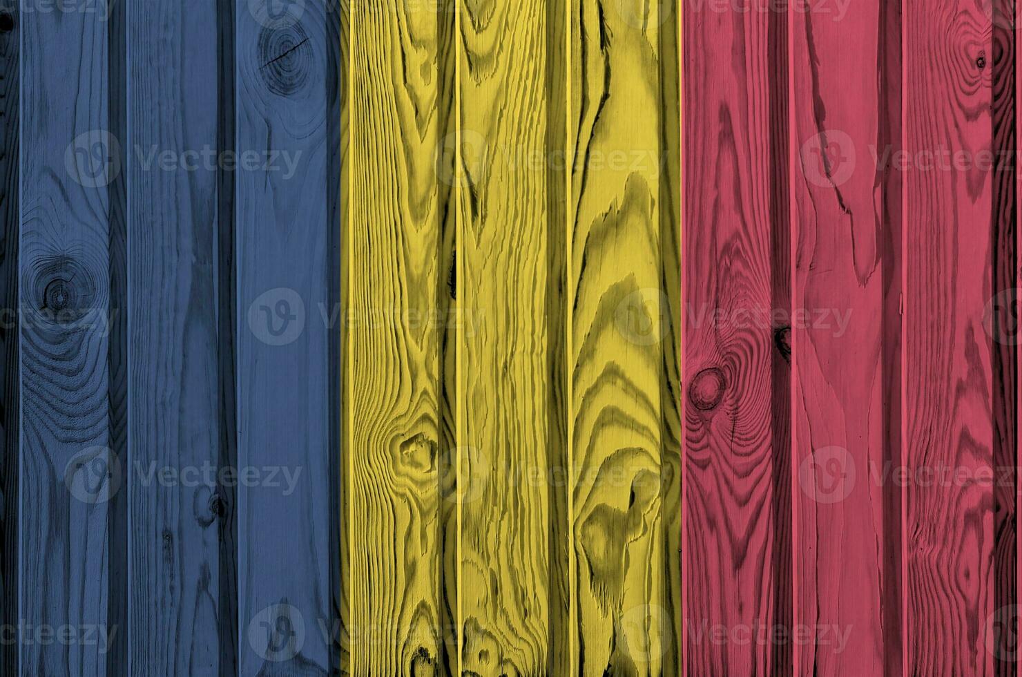 Chad flag depicted in bright paint colors on old wooden wall. Textured banner on rough background photo