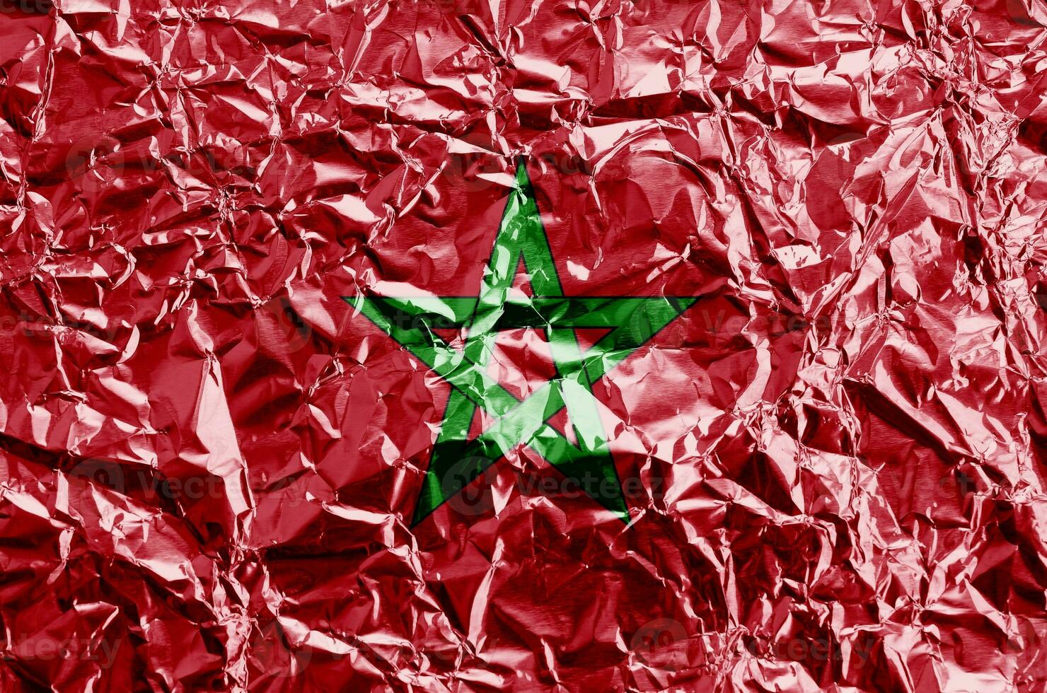 Morocco flag depicted in paint colors on shiny crumpled aluminium foil closeup. Textured banner on rough background photo