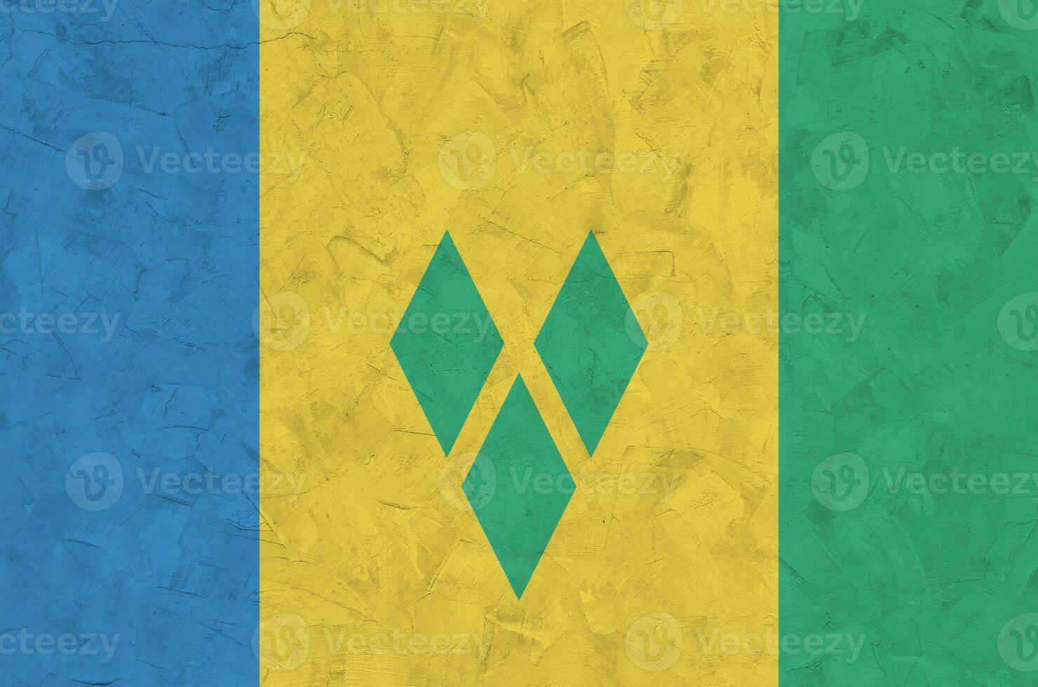 Saint Vincent and the Grenadines flag depicted in bright paint colors on old relief plastering wall. Textured banner on rough background photo