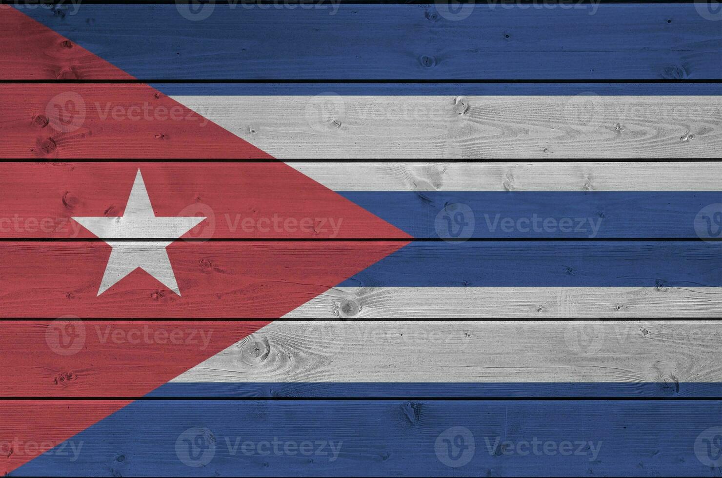 Cuba flag depicted in bright paint colors on old wooden wall. Textured banner on rough background photo