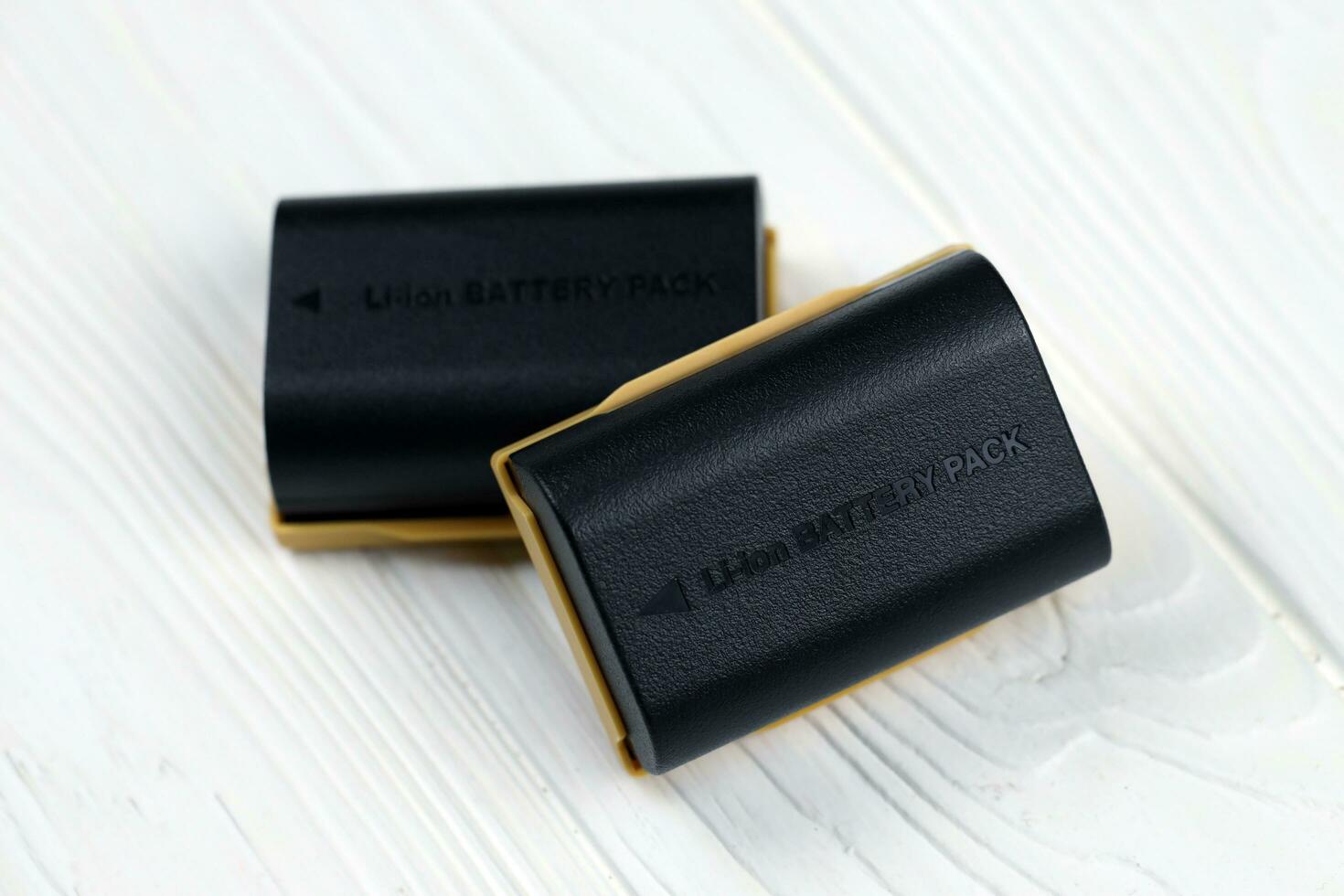 KHARKOV, UKRAINE - MARCH 14, 2021 Kastar lithium-ion or li-ion rechargeable batteries for modern DSLR photocameras on white table photo