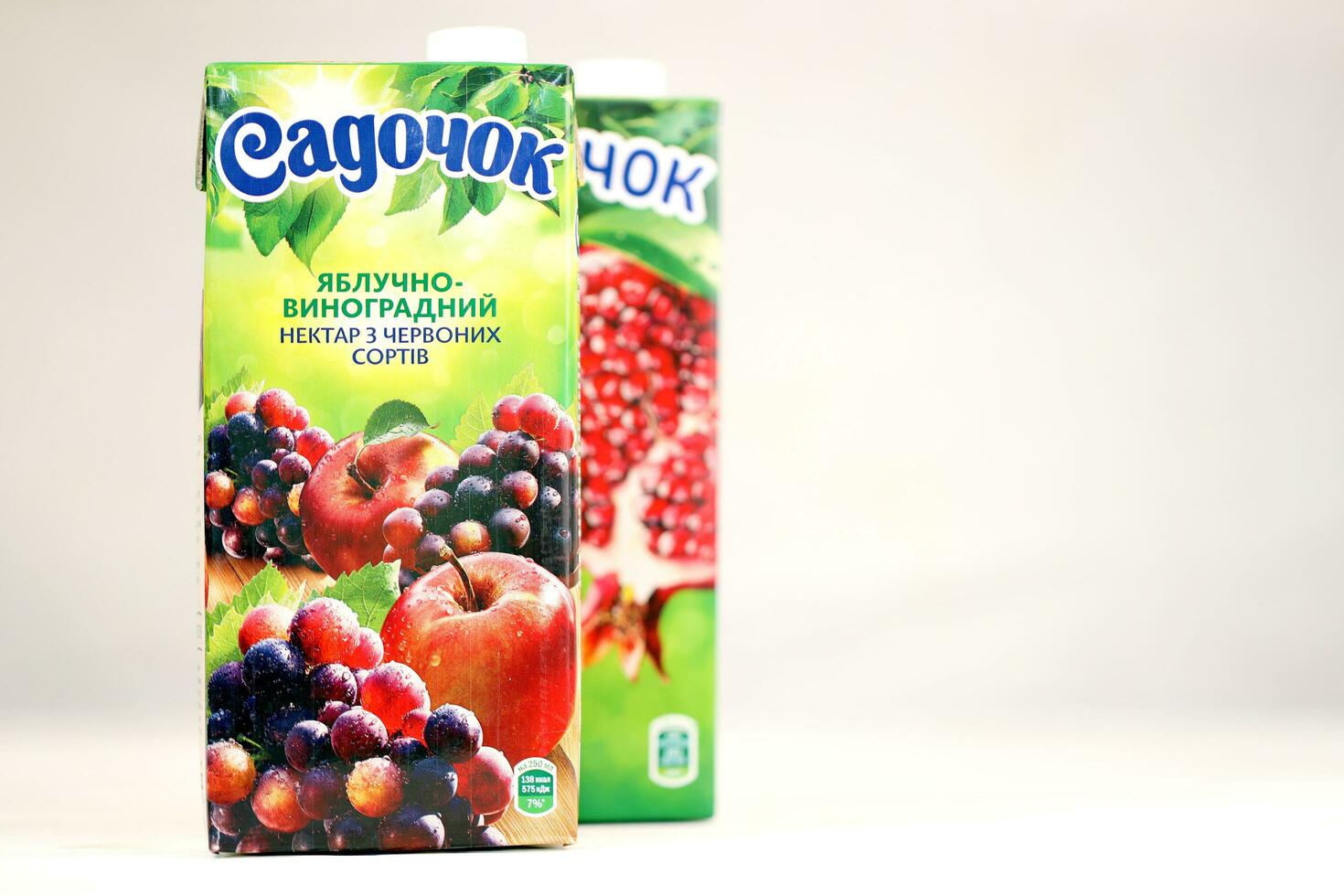 KHARKOV, UKRAINE - JULY 2, 2021 Sadochok Apple and grape nectar from red varieties and apple with pomegranate juice tetra-packs photo