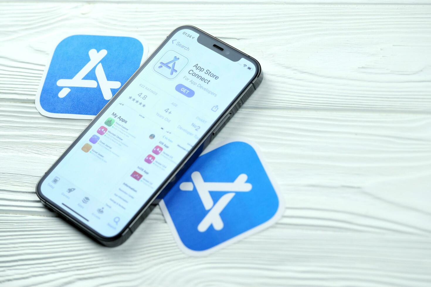 KHARKOV, UKRAINE - MARCH 5, 2021 App store connect icon and application from App store on iPhone 12 pro display screen on white table photo