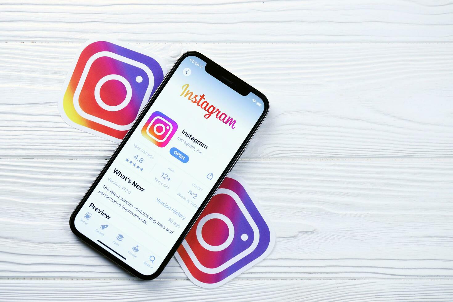KHARKOV, UKRAINE - MARCH 5, 2021 Instagram icon and application from App store on iPhone 12 pro display screen on white table photo