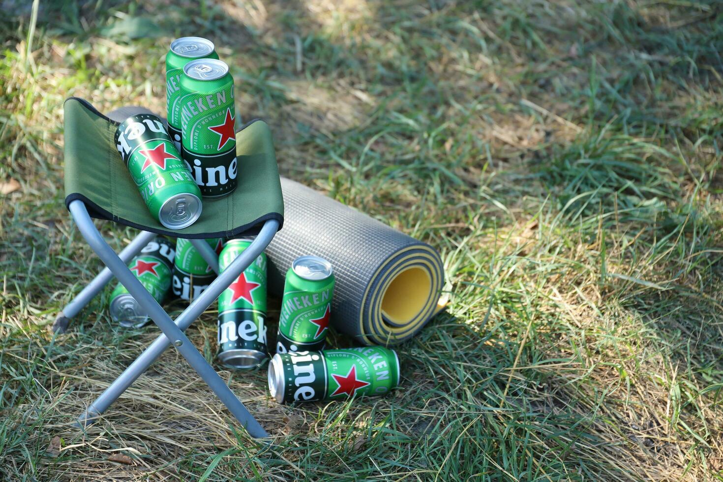 KHARKOV, UKRAINE - JULY 31, 2021 Green tin cans of Heineken lager beer produced by the Dutch brewing company Heineken N.V. photo