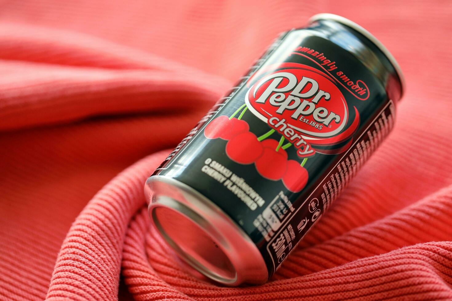 KYIV, UKRAINE - JULY 7, 2023 Dr Pepper cherry drink can on red background photo