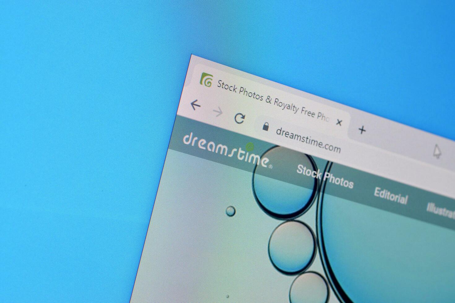 Homepage of dreamstime website on the display of PC, url - dreamstime.com. photo