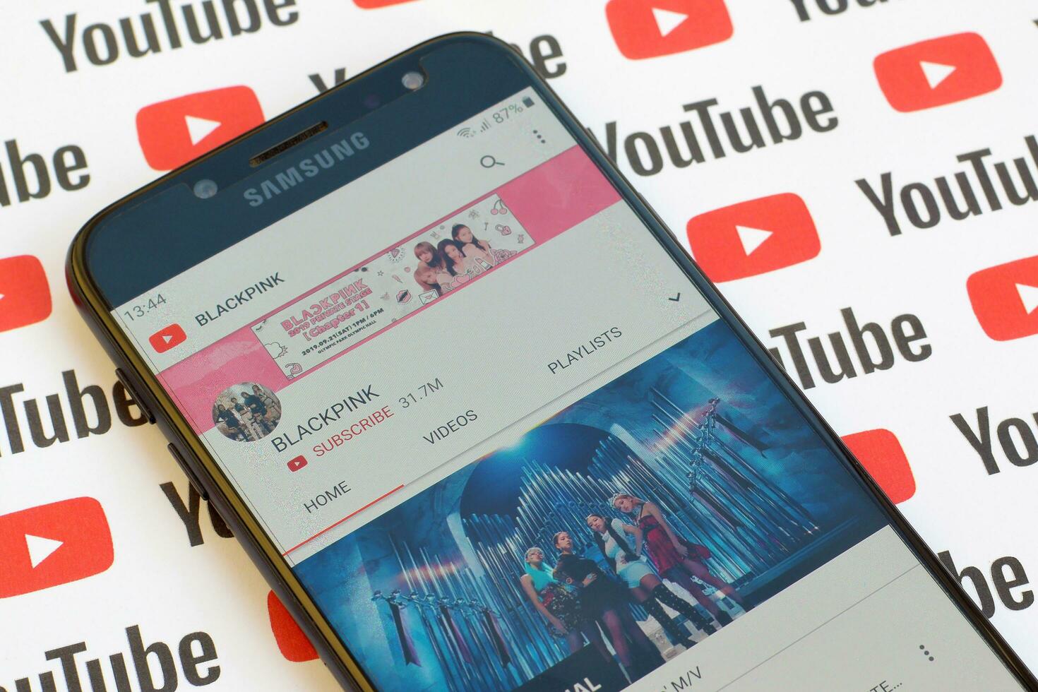 Blackpink official youtube channel on smartphone screen on paper youtube background. photo