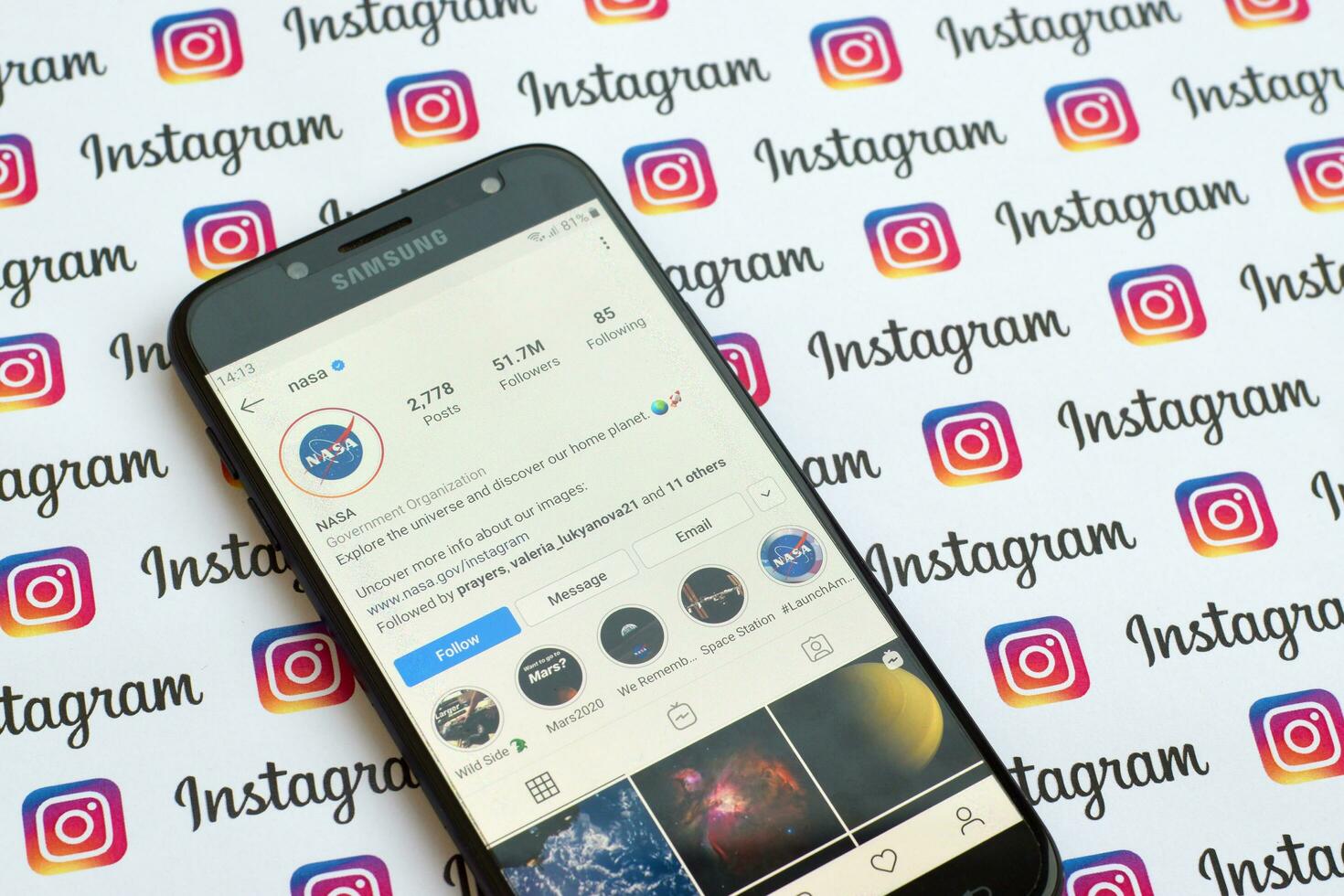 Nasa official instagram account on smartphone screen on paper instagram banner. photo