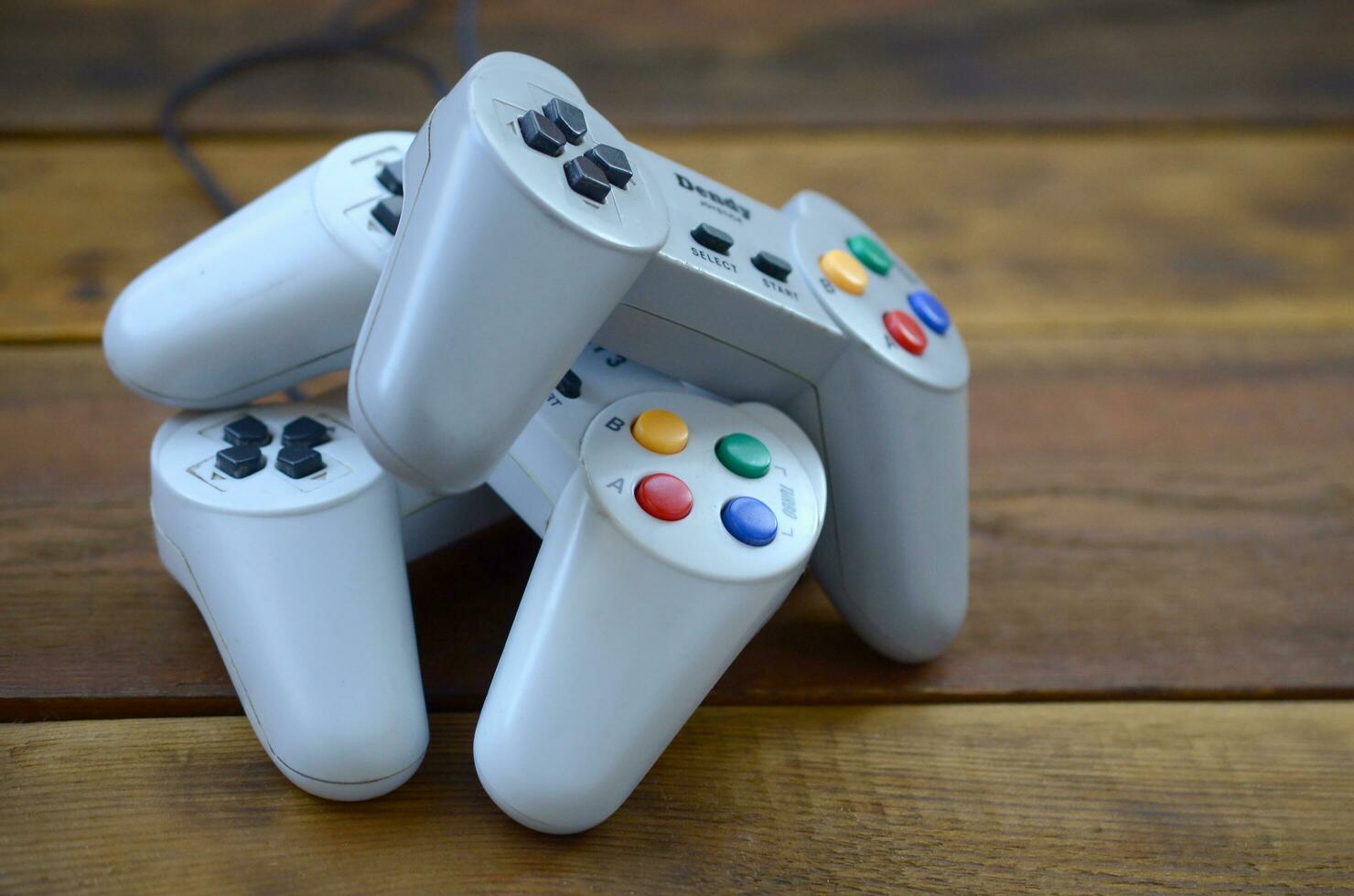 Dendy video game console classic controllers on a wooden table photo