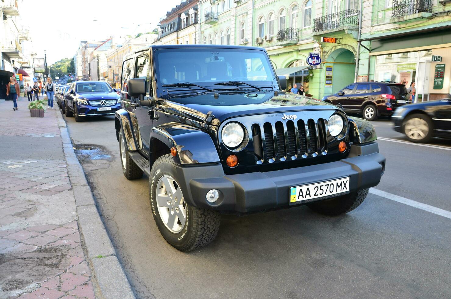 Jeep Wrangler Sahara Black with BFGoodrich All terrain T A tires on Kyiv street photo