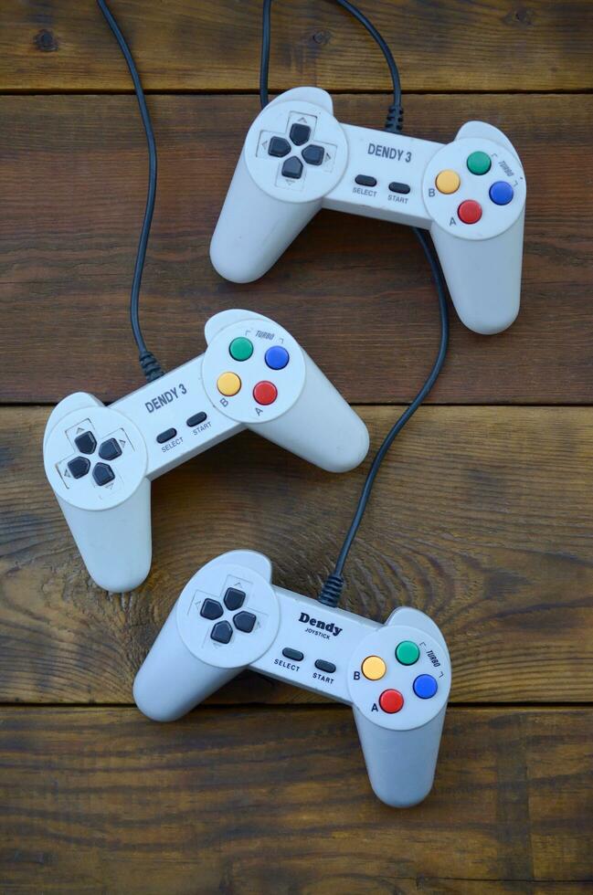 Dendy video game console classic controllers on a wooden table photo