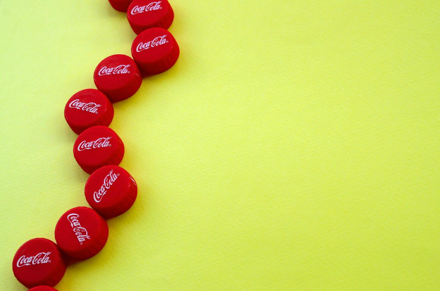 Many red caps with coca cola logo on yellow background 31235328 Stock