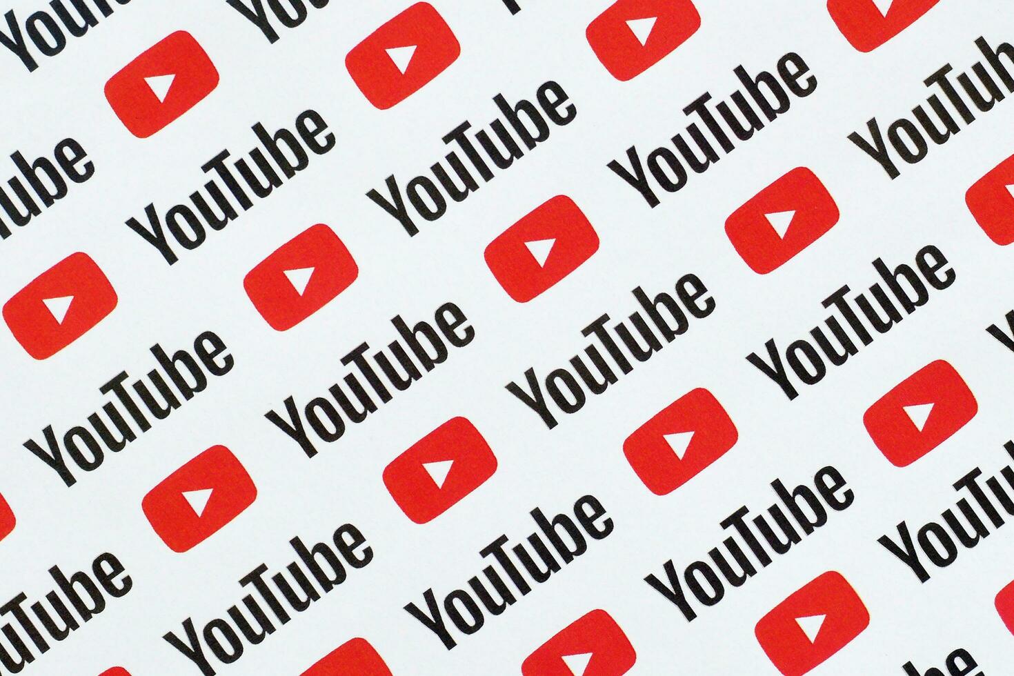 Youtube pattern printed on paper with small youtube logos and inscriptions. YouTube is Google subsidiary and American most popular video-sharing platform photo