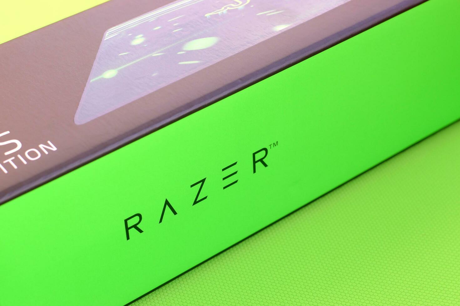 Razer Goliathus Speed Gaming green mouse pad and box with logo. Razer global gaming hardware manufacturing company, as well as an esports and financial services photo
