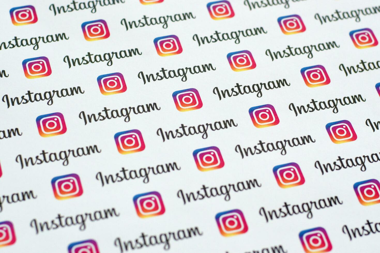 Instagram pattern printed on paper with small instagram logos and inscriptions. Instagram is American photo and video-sharing social networking service owned by Facebook