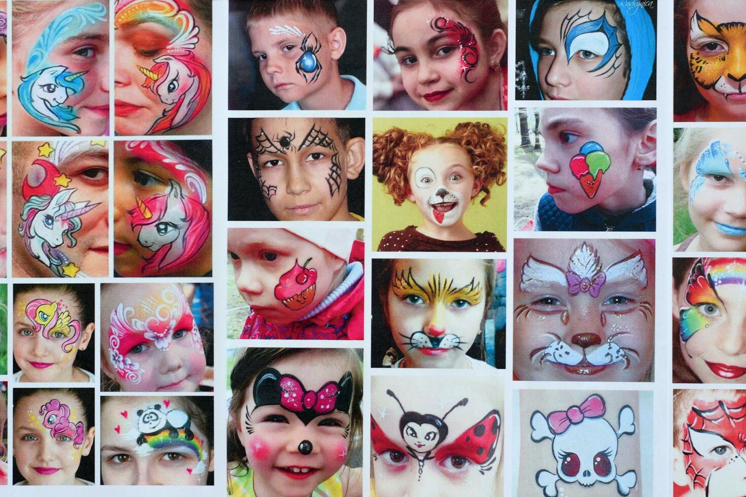 Many catalog pages with printed kids portraits with colorful face painting photo