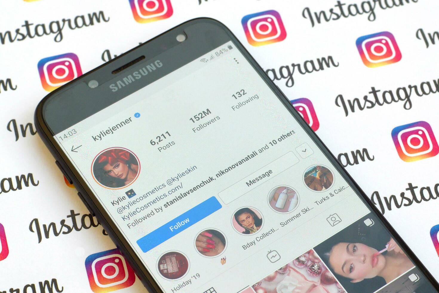 Kylie Jenner official instagram account on smartphone screen on paper instagram banner. photo