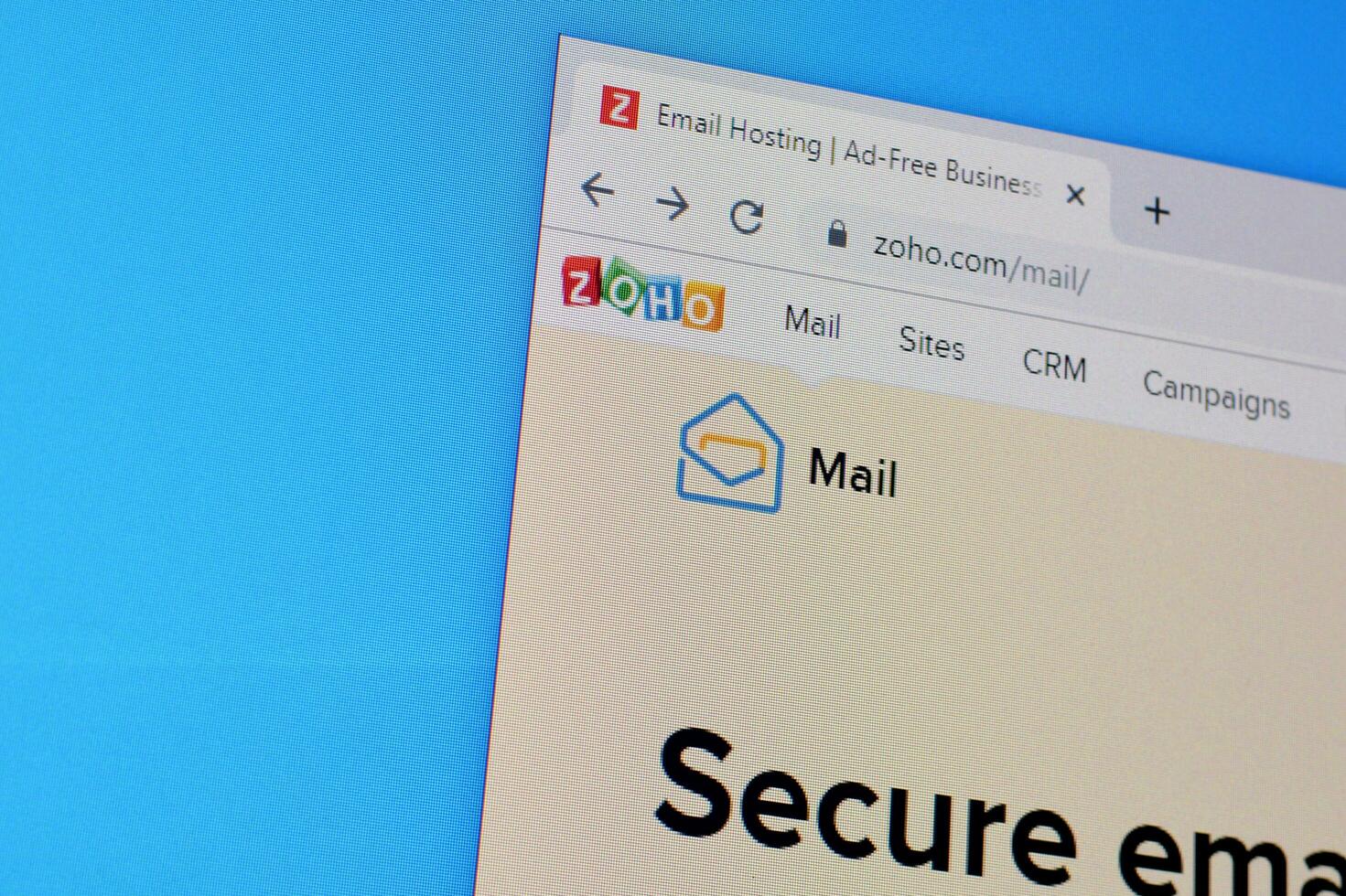 Homepage of zoho mail website on the display of PC, url - www.zoho.com. photo