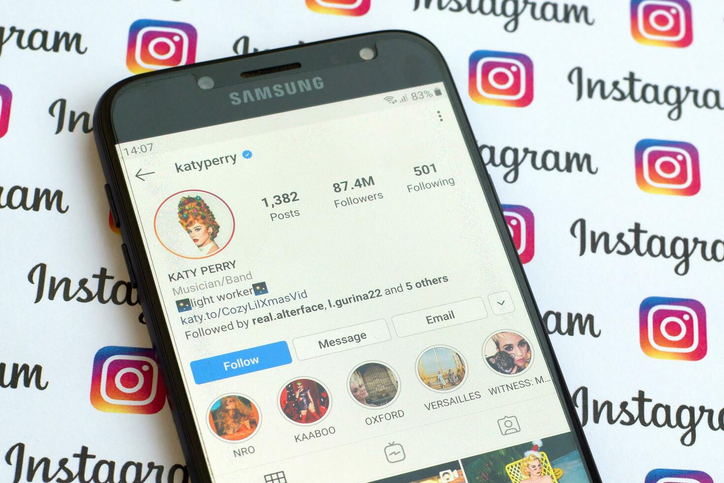 Katy Perry official instagram account on smartphone screen on paper instagram banner. photo