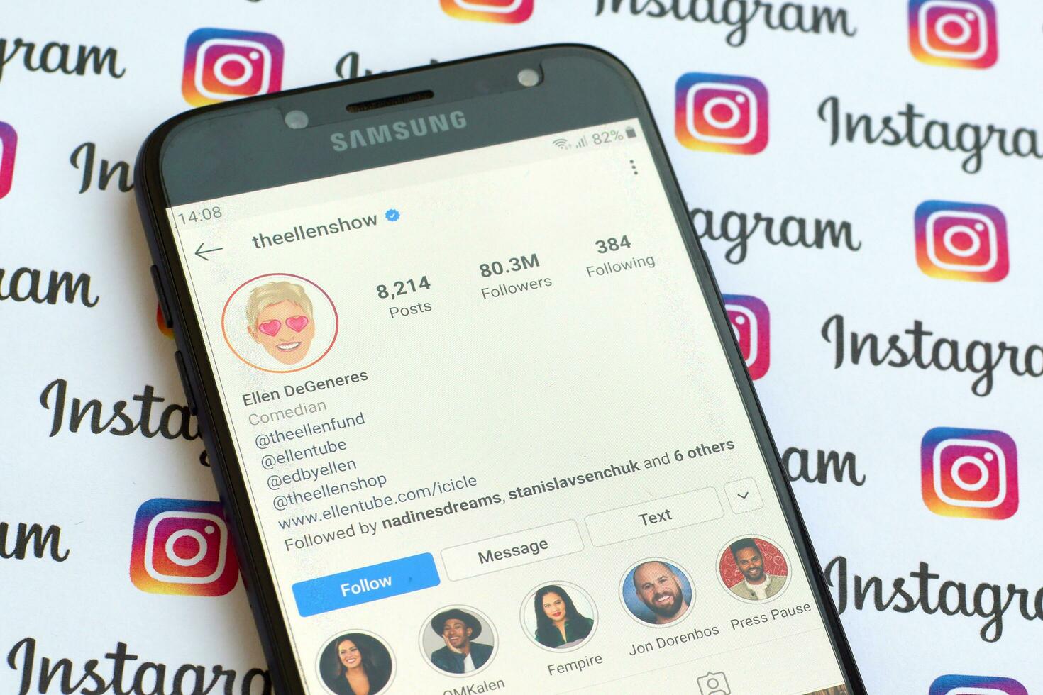 Ellen DeGeneres official instagram account on smartphone screen on paper instagram banner. photo