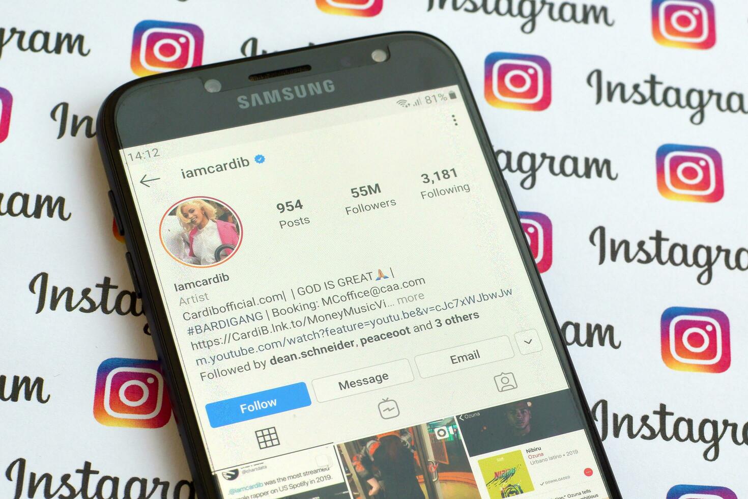 Cardi B official instagram account on smartphone screen on paper instagram banner. photo