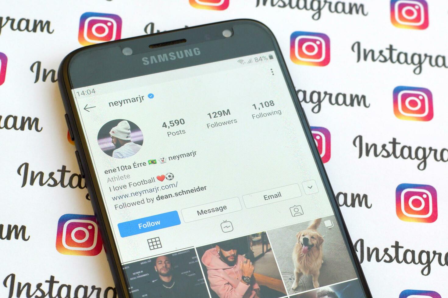 Neymar jr official instagram account on smartphone screen on paper instagram banner. photo