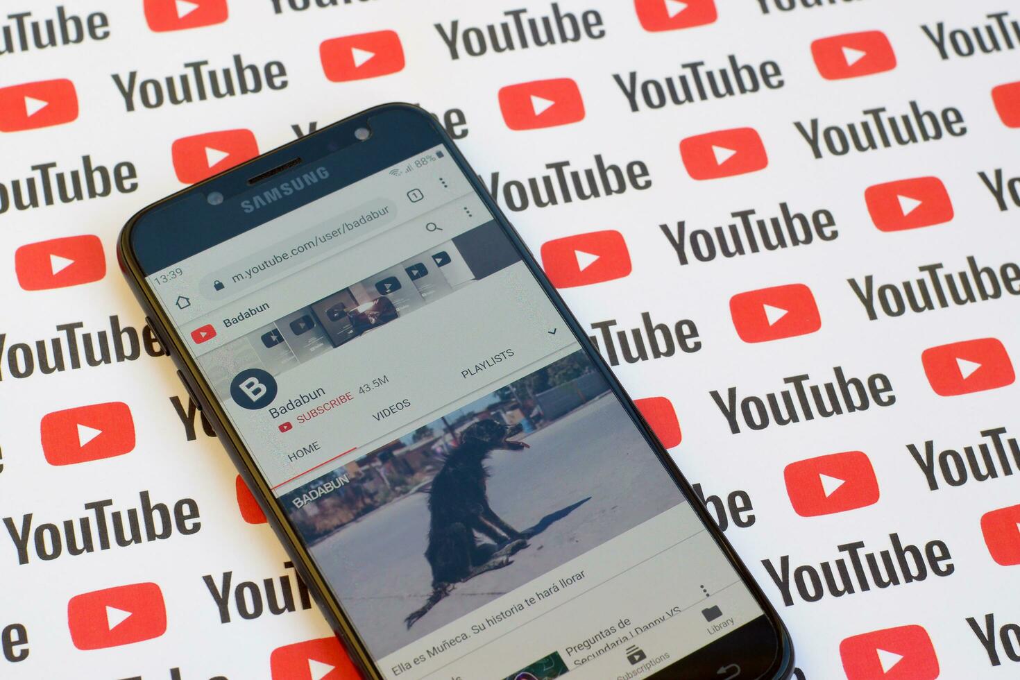 Badabun official youtube channel on smartphone screen on paper youtube background. photo
