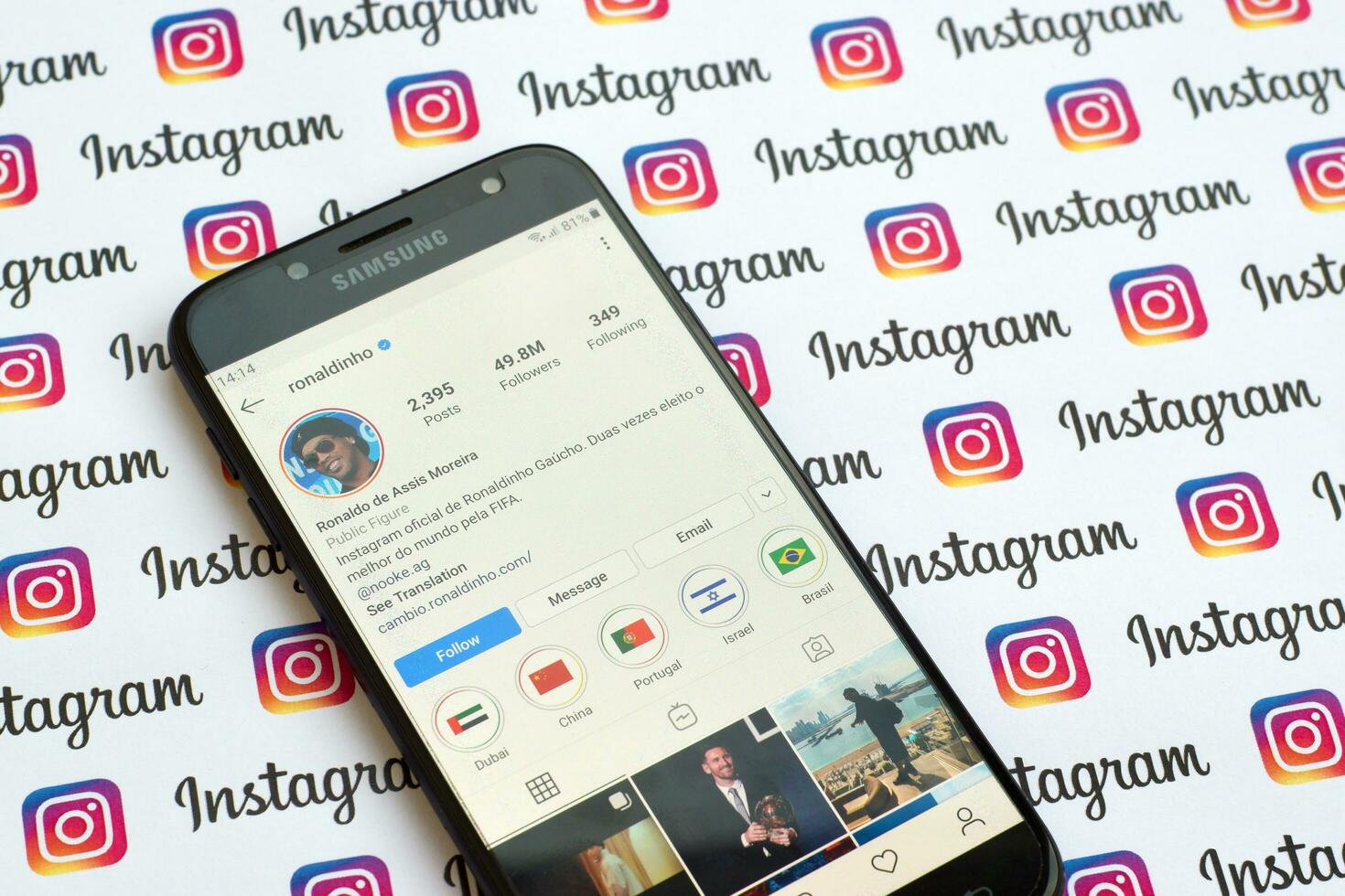 Ronaldinho official instagram account on smartphone screen on paper instagram banner. photo