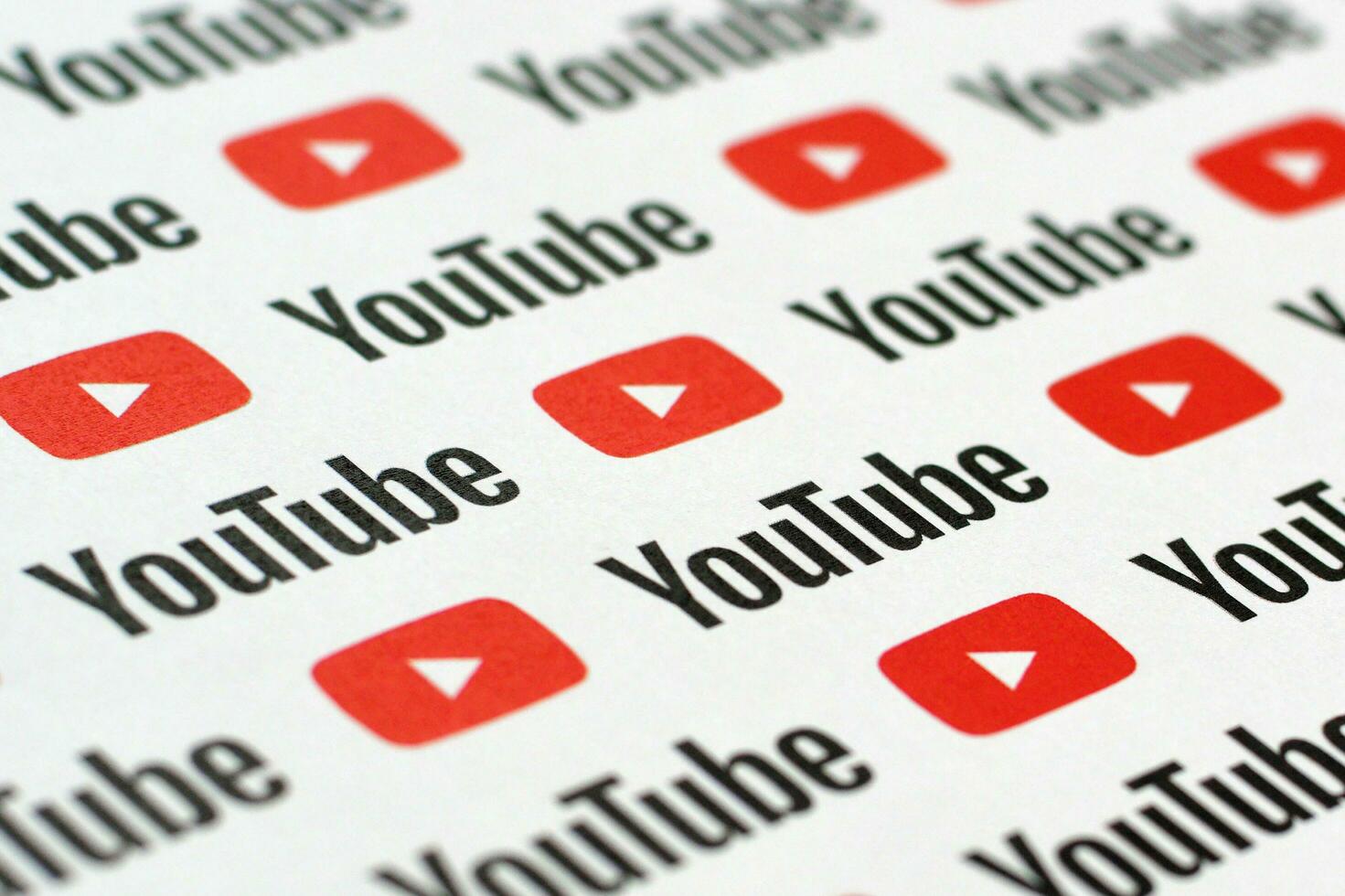 Youtube pattern printed on paper with small youtube logos and inscriptions. YouTube is Google subsidiary and American most popular video-sharing platform photo