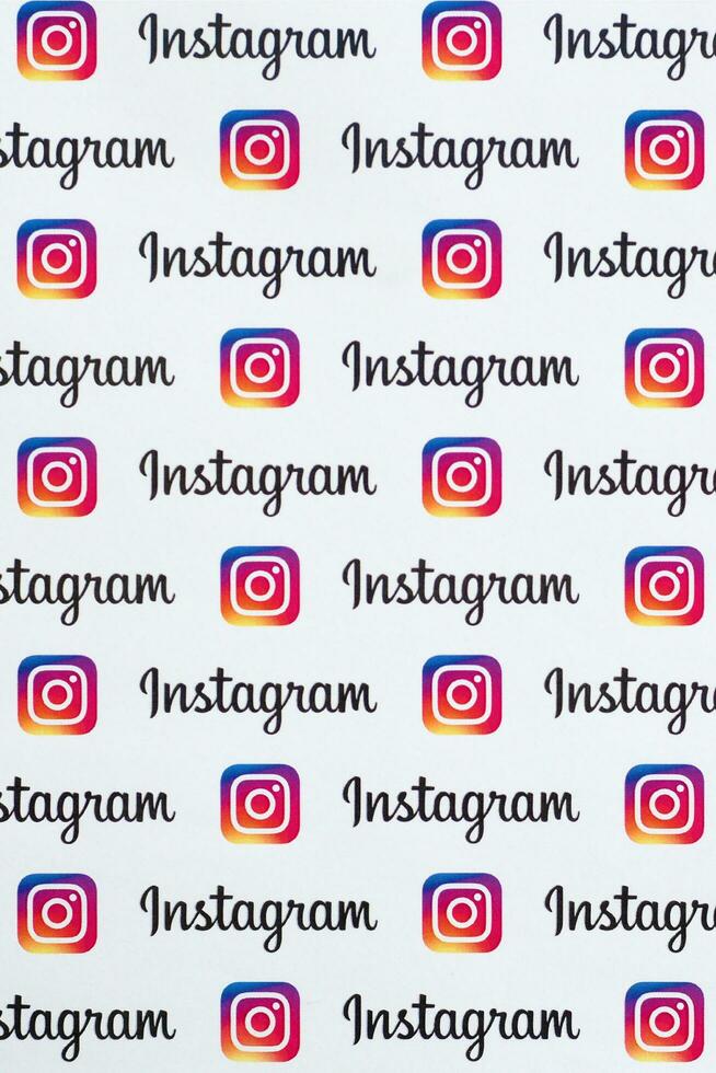 Instagram pattern printed on paper with small instagram logos and inscriptions. Instagram is American photo and video-sharing social networking service owned by Facebook