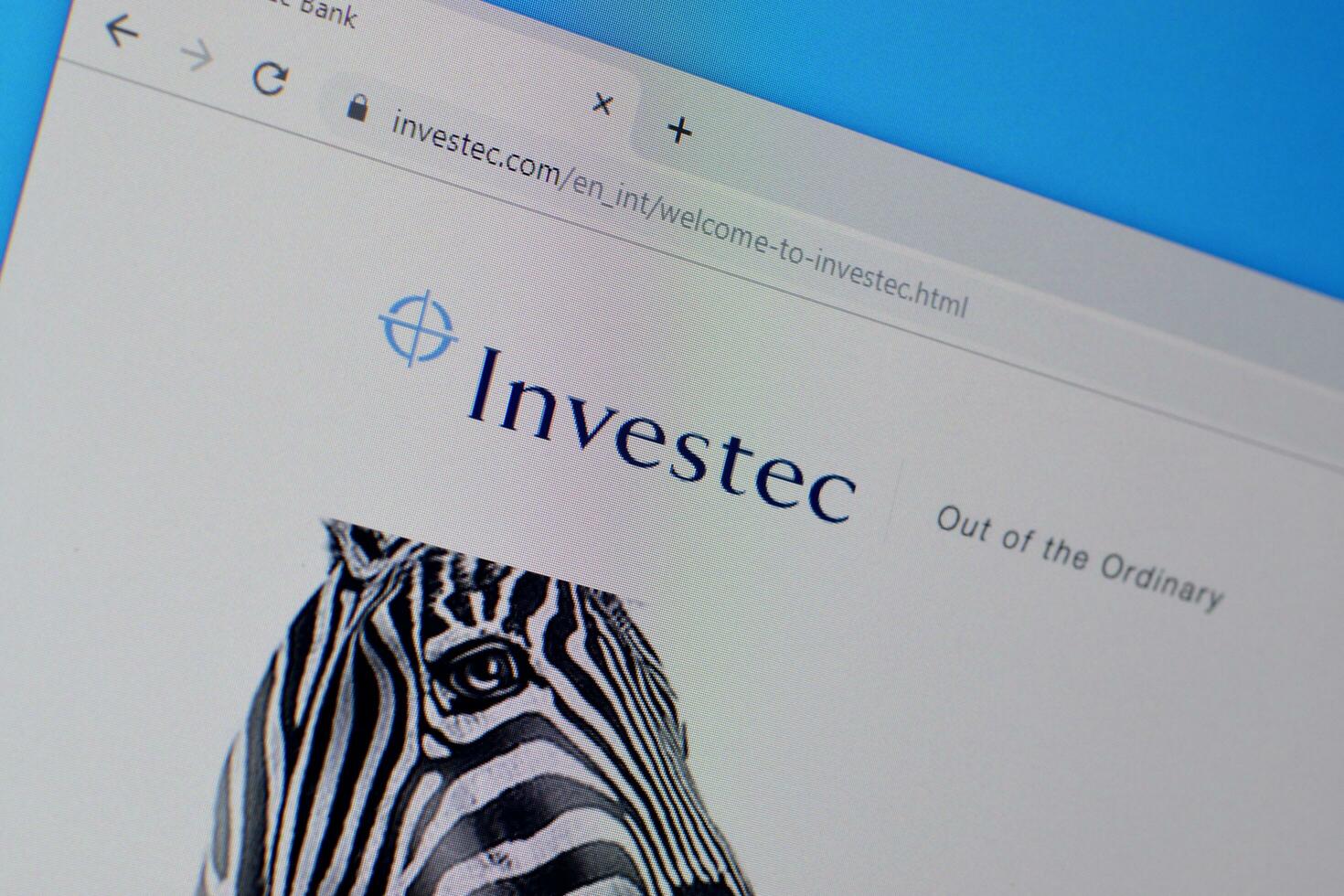 Homepage of investec website on the display of PC, url - investec.com. photo