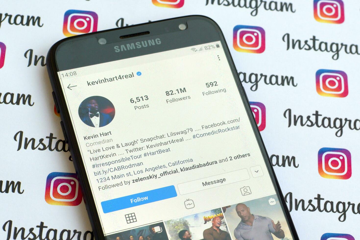 Kevin Hart official instagram account on smartphone screen on paper instagram banner. photo