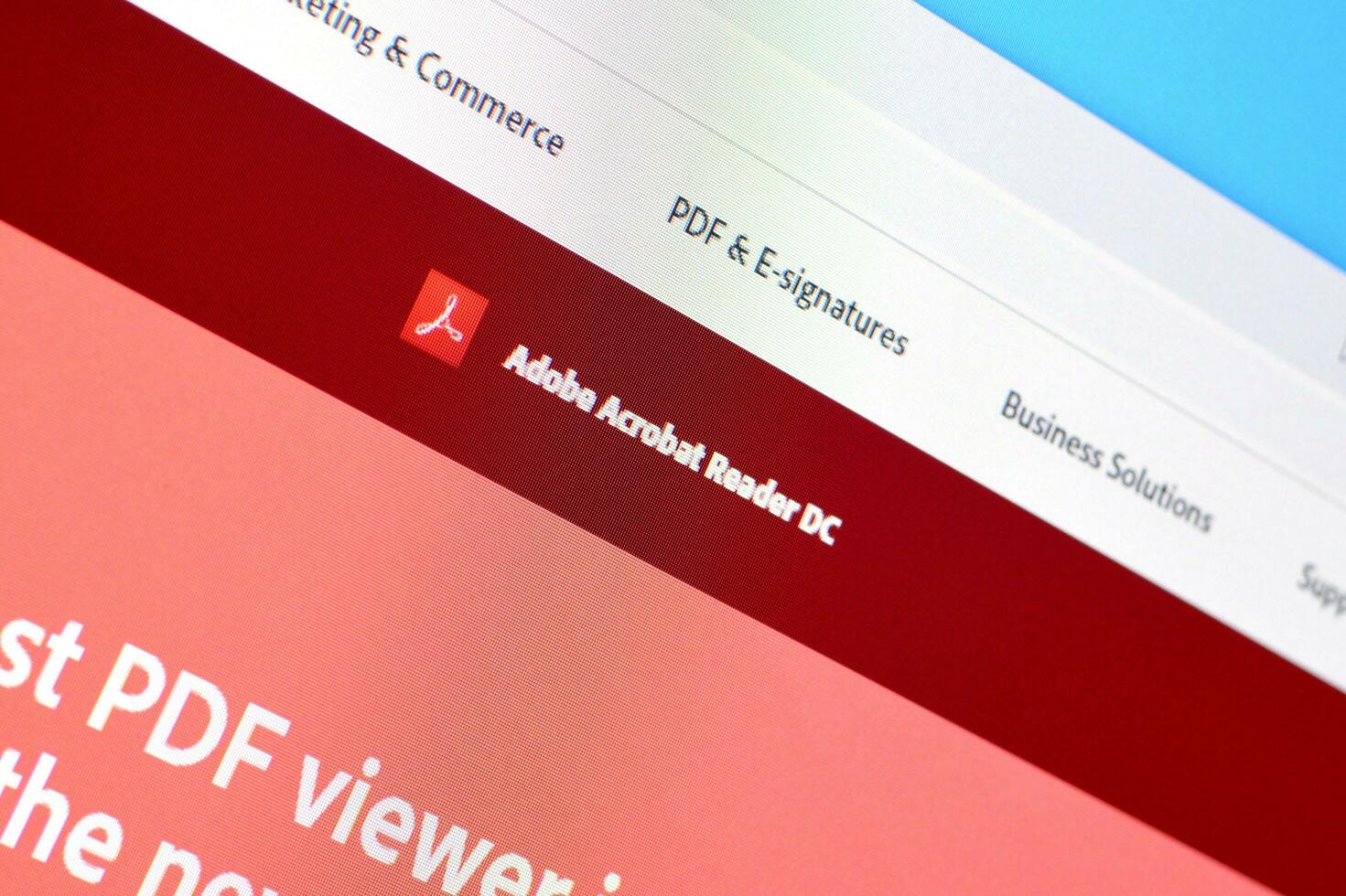 Web page of adobe acrobat reader product on official website on the display of PC photo