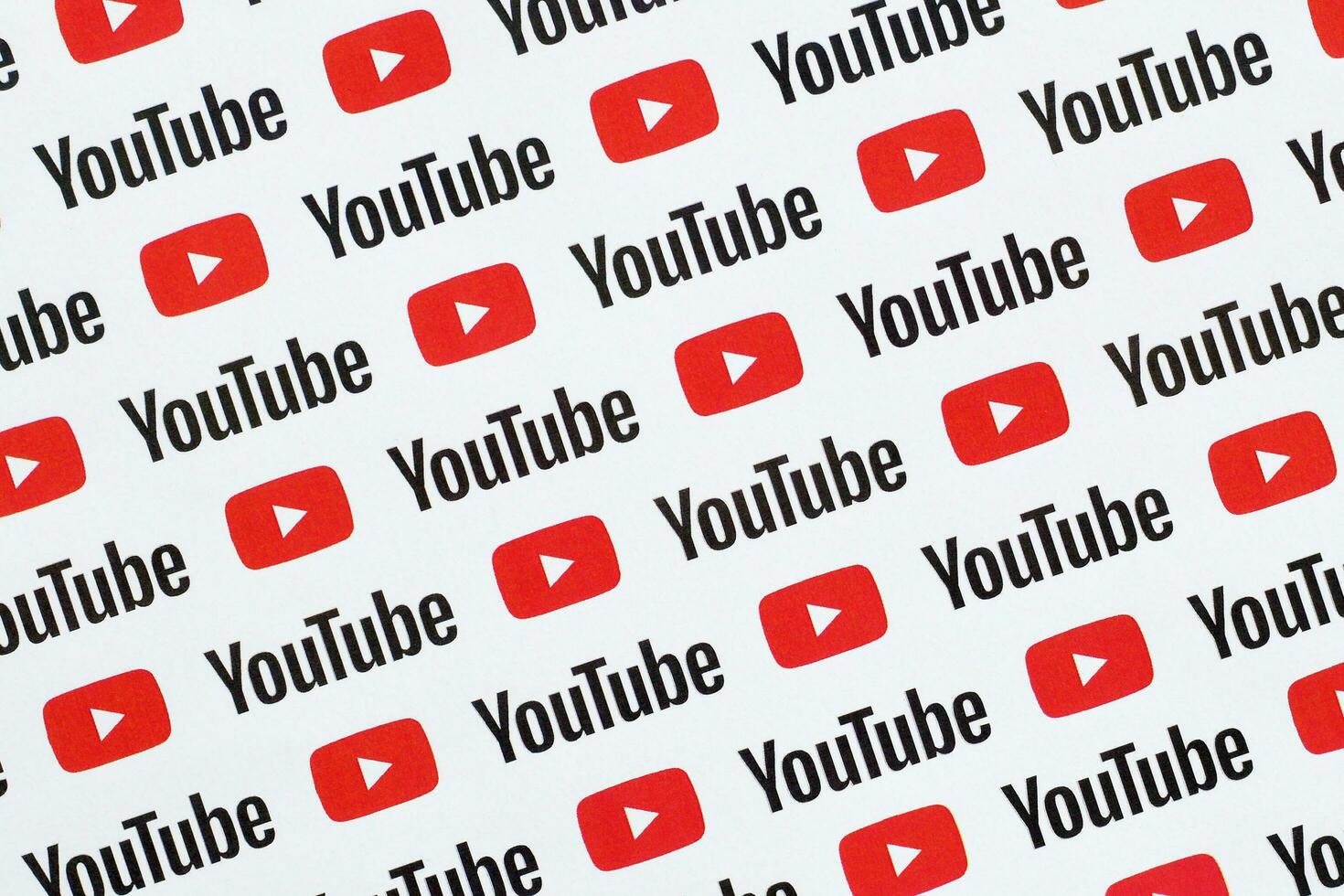 Youtube pattern printed on paper with small youtube logos and inscriptions. YouTube is Google subsidiary and American most popular video-sharing platform photo