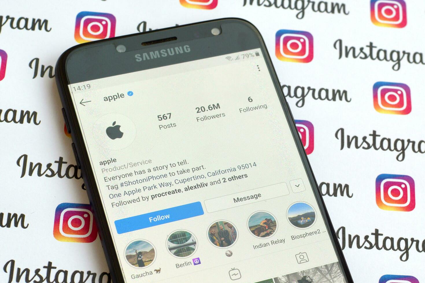 Apple official instagram account on smartphone screen on paper instagram banner. photo