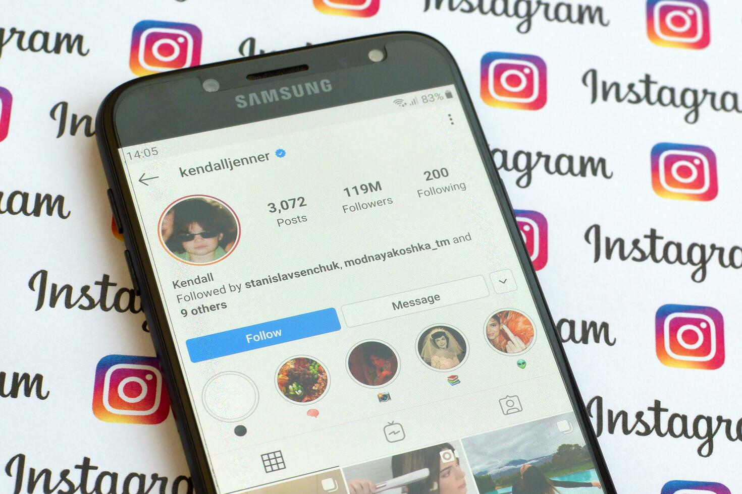 Kendall Jenner official instagram account on smartphone screen on paper instagram banner. photo