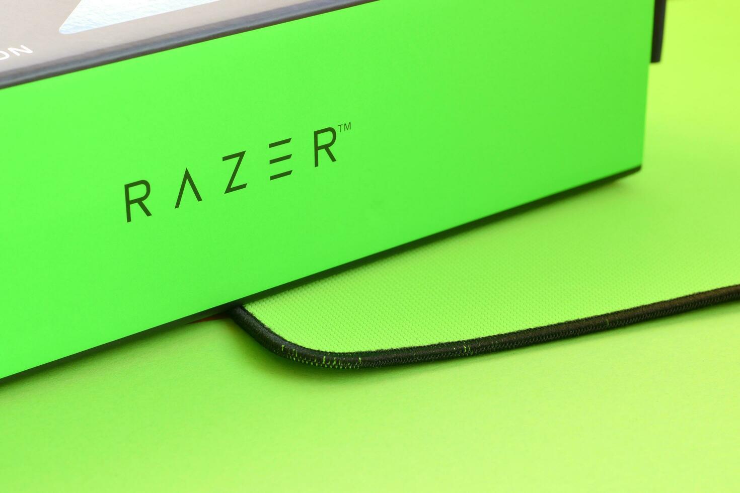 Razer Goliathus Speed Gaming green mouse pad and box with logo. Razer global gaming hardware manufacturing company, as well as an esports and financial services photo