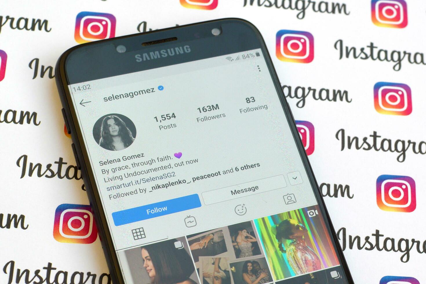 Selena Gomez official instagram account on smartphone screen on paper instagram banner. photo