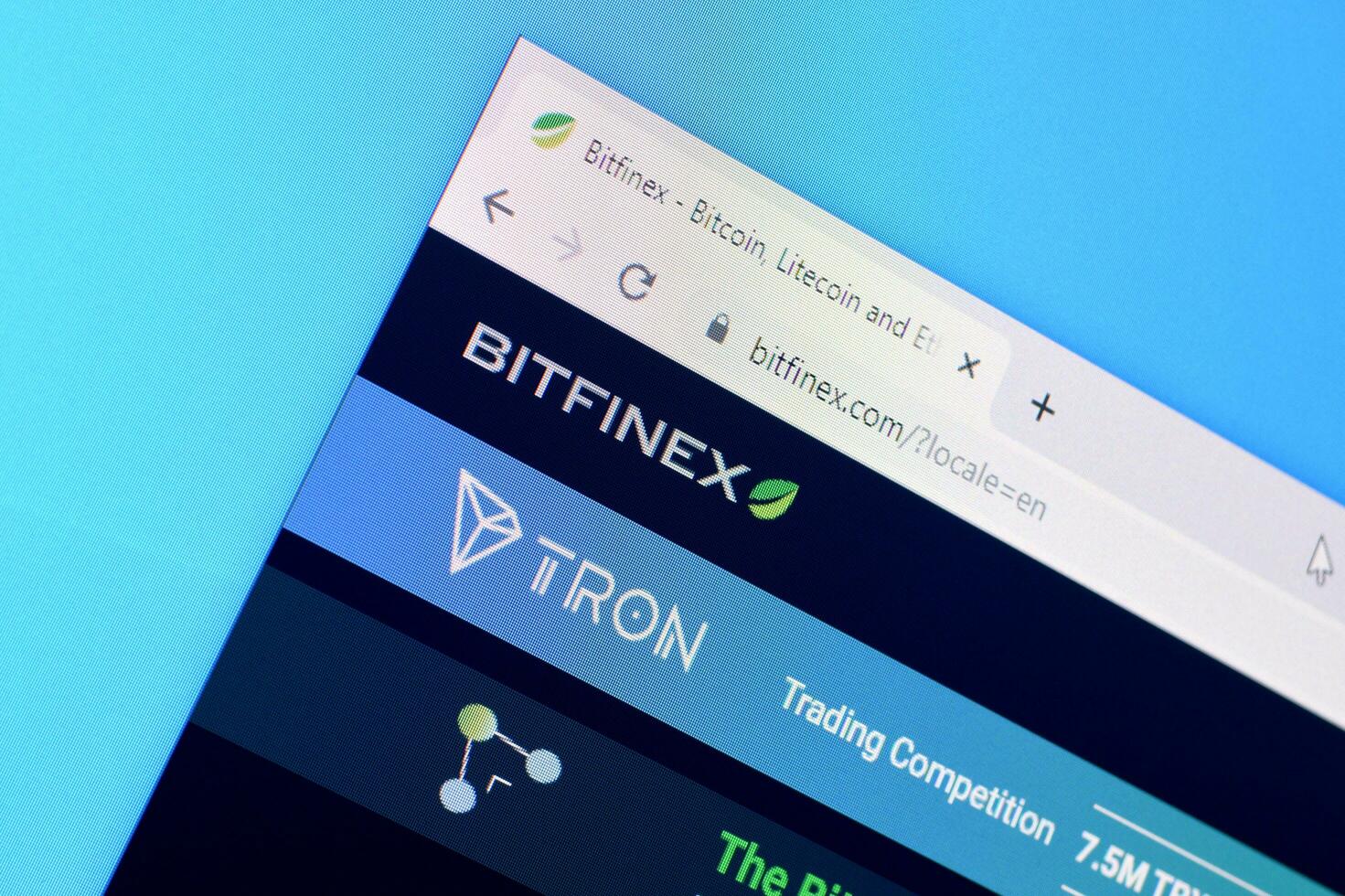 Homepage of bitfinex website on the display of PC, url - bitfinex.com. photo