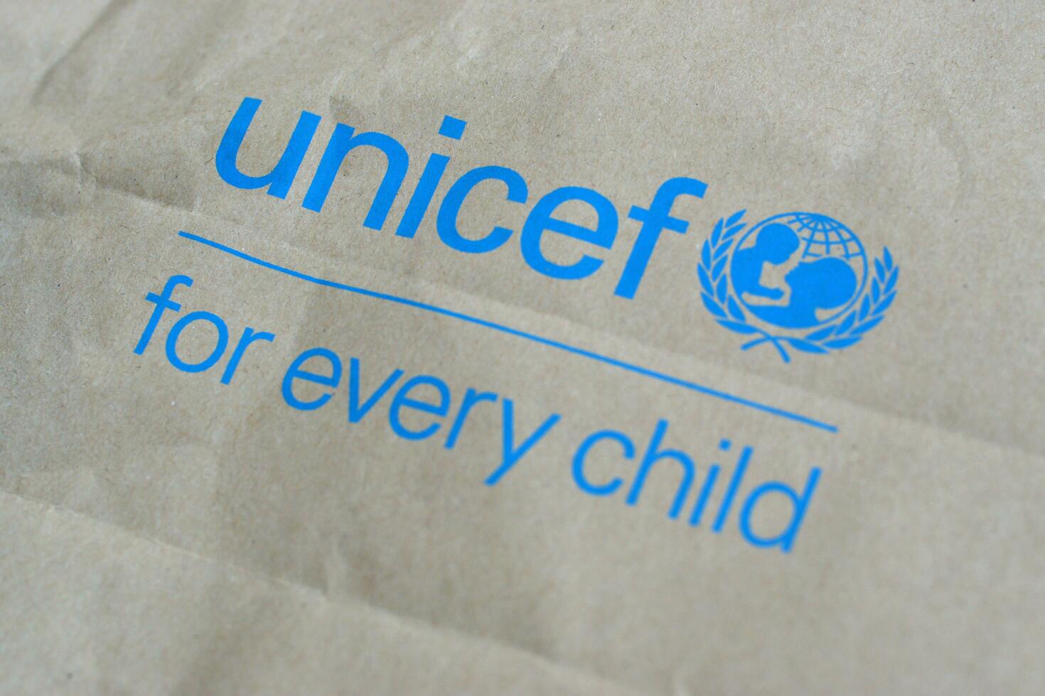 Unicef blue logo on brown paper bag, United Nations Childrens Fund is agency responsible for providing humanitarian and developmental aid to children around the world photo