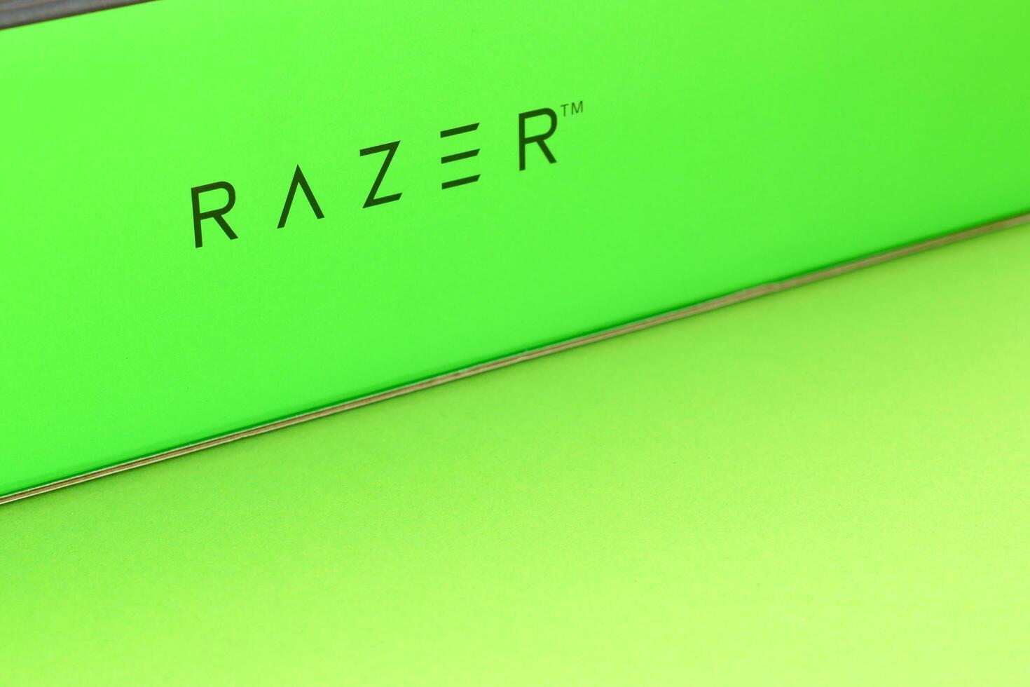 Razer Goliathus Speed Gaming green mouse pad and box with logo. Razer global gaming hardware manufacturing company, as well as an esports and financial services photo