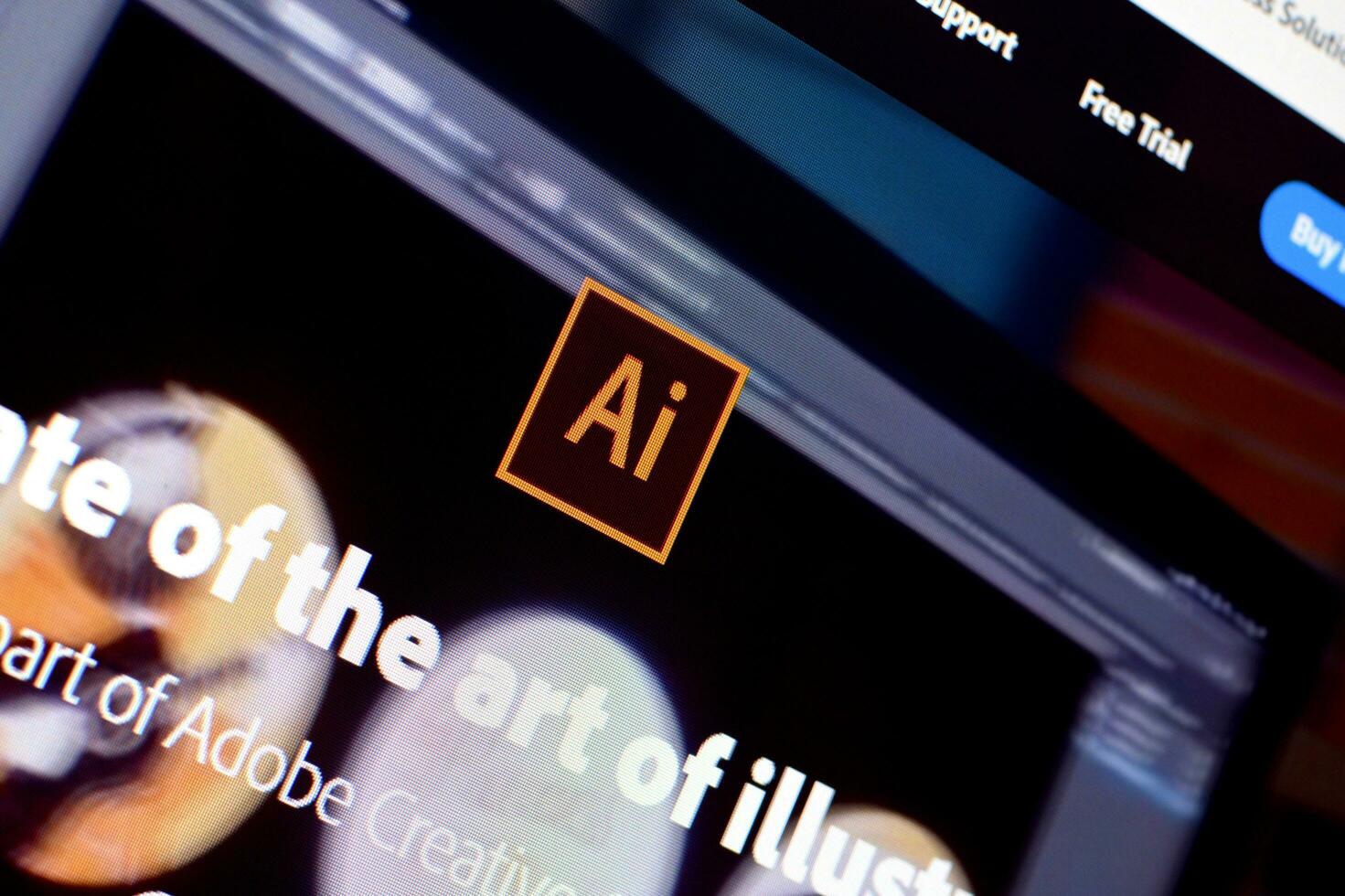 Web page of adobe illustrator product on official website on the display of PC photo