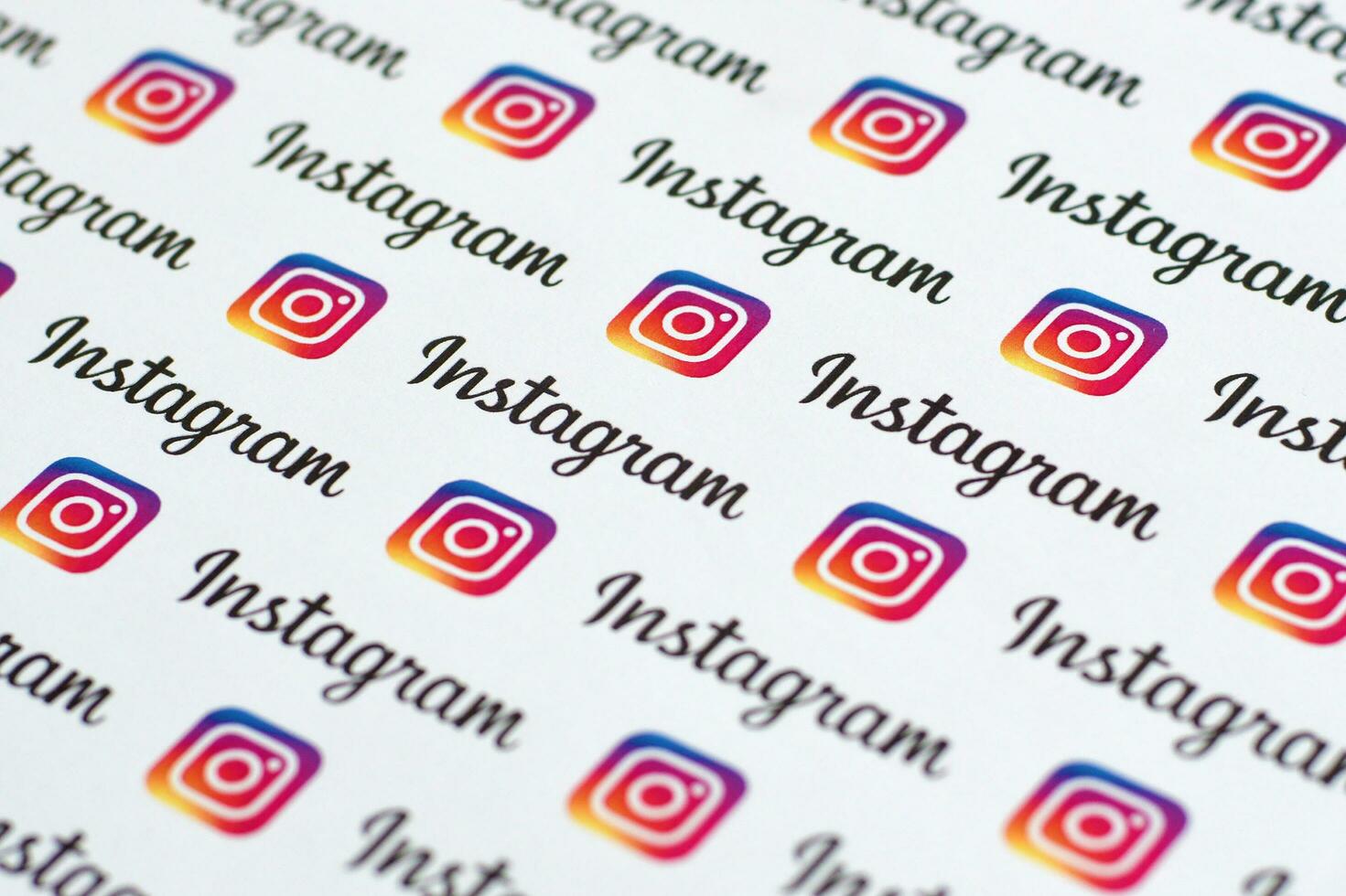 Instagram pattern printed on paper with small instagram logos and inscriptions. Instagram is American photo and video-sharing social networking service owned by Facebook