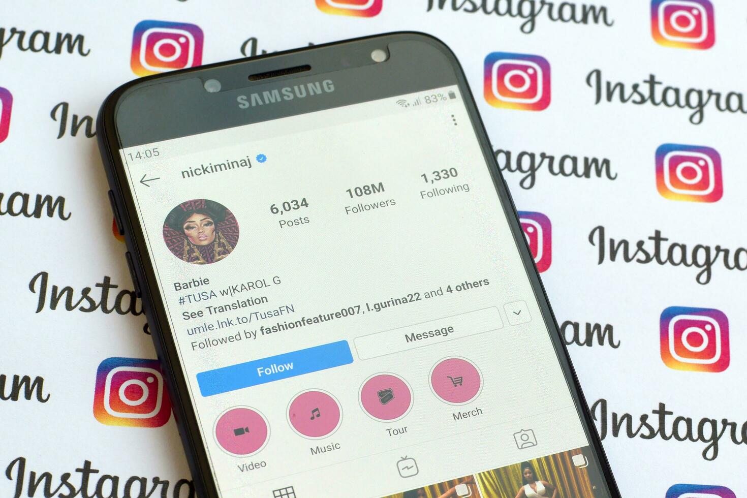 Nicki Minaj official instagram account on smartphone screen on paper instagram banner. photo