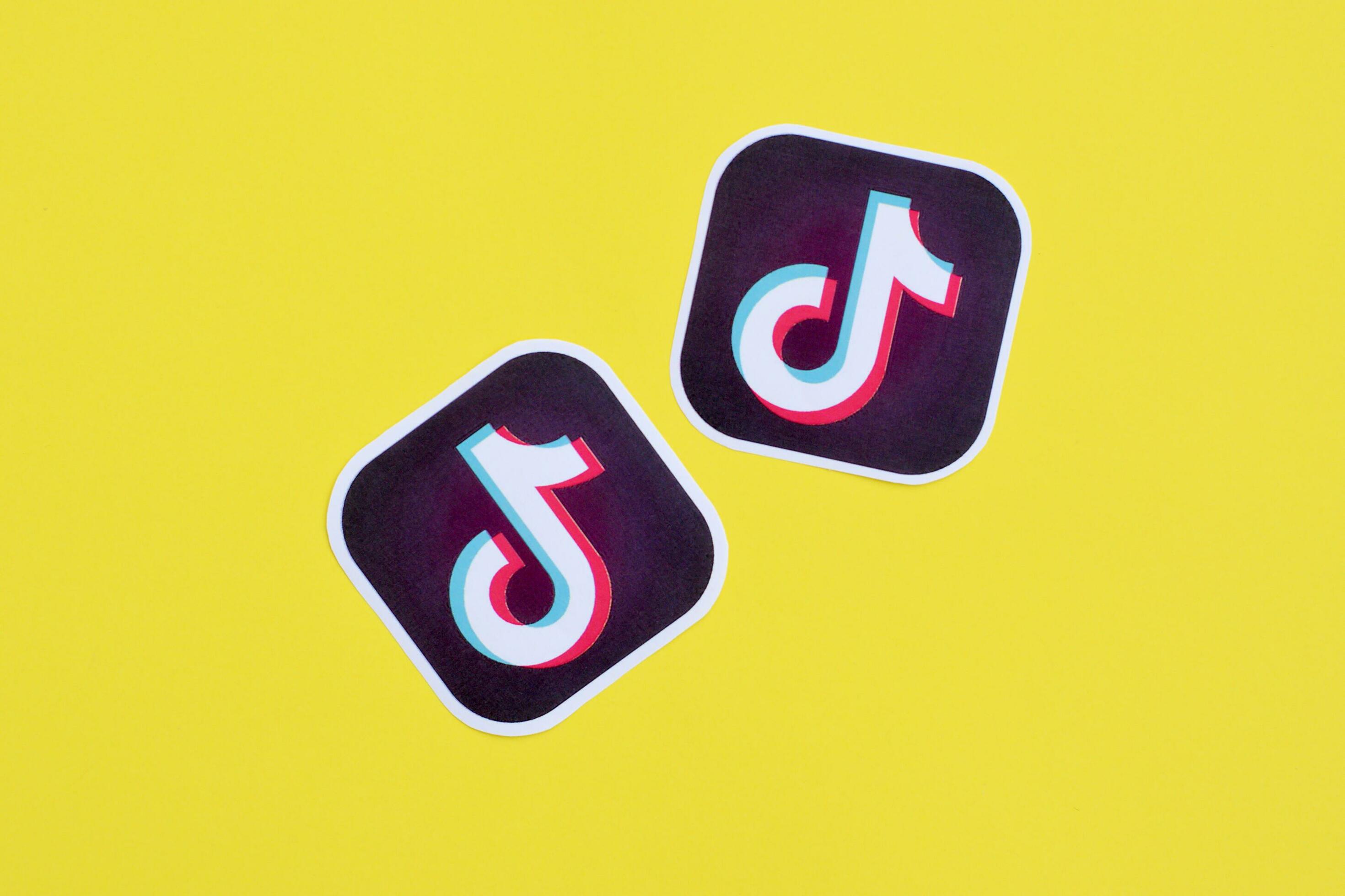 Tiktok paper logo on yellow background. TikTok is a popular video