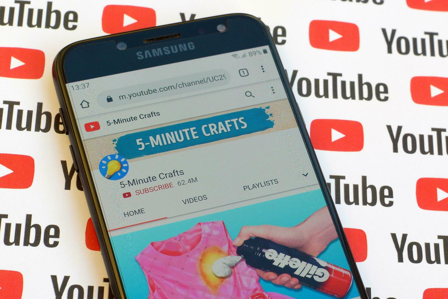 5-Minute Crafts official youtube channel on smartphone screen on paper youtube background. photo