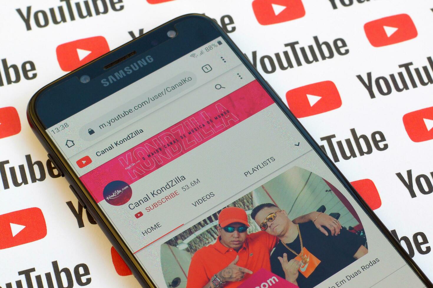 Canal KondZilla official youtube channel on smartphone screen on paper youtube background. photo
