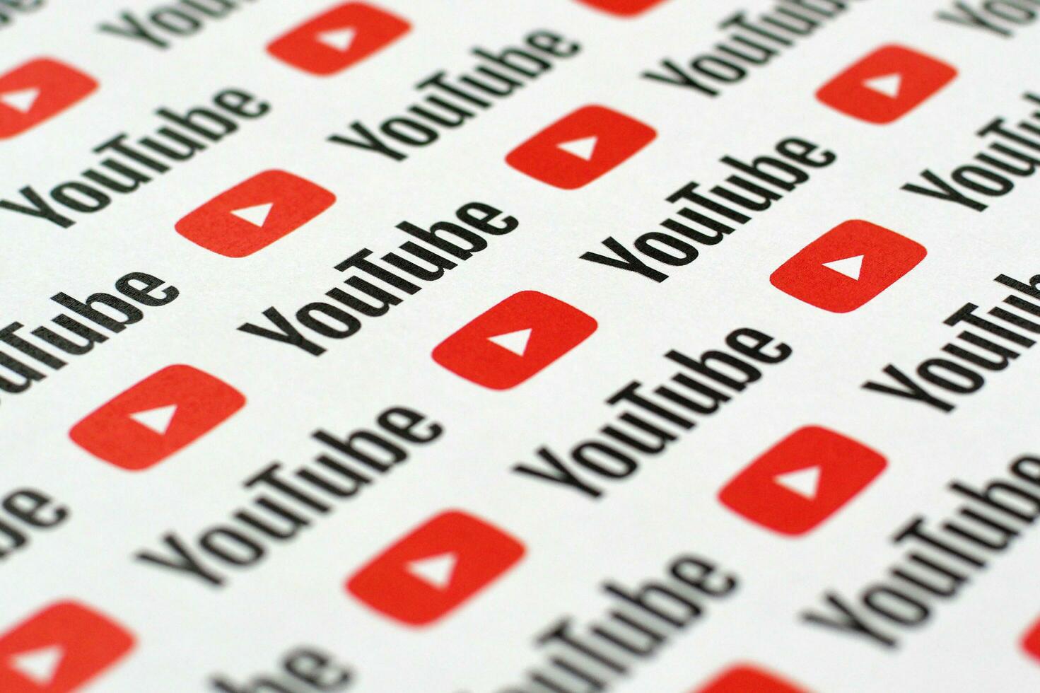 Youtube pattern printed on paper with small youtube logos and inscriptions. YouTube is Google subsidiary and American most popular video-sharing platform photo